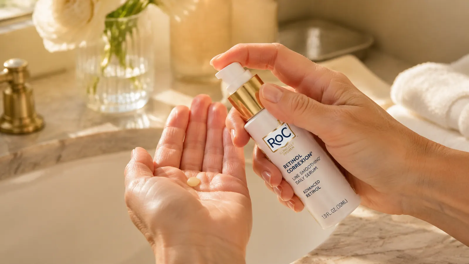 Small glass bottle of RoC Retinol Correxion serum resting on a bathroom shelf beside a clean white towel